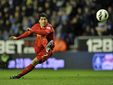 Liverpool's Luis Suarez scores from a free kick against Wigan on March 2, 2013