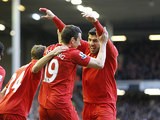 Stewart Downing is congratulated by team mate Luis Suarez after scoring his team's second against Spurs on March 10, 2013