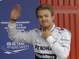 Mercedes driver Nico Rosberg of Germany waves after setting the pole position in the qualifying session for the Spanish Grand Prix on May 11, 2013