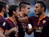 Roma's Adem Ljajic is congratulated by team mates after scoring his team's third goal against Hellas Verona on September 1, 2013