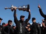 Oracle Team USA tactician Sir Ben Ainslie holds the America's Cup trophy as he celebrates onstage after they beat Emirates Team New Zealand to defend the America's Cup during the final race on September 25, 2013