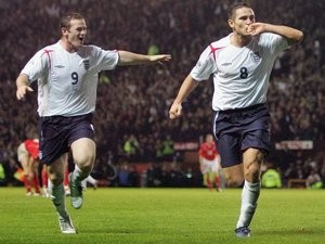 Wayne Rooney and Frank Lampard celebrate the latter's goals during a World Cup qualifier against Poland on October 12, 2005.