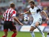 Michu of Swansea City faces upto Lee Cattermole of Sunderland during the Barclays Premier League match between Swansea City and Sunderland on October 19, 2013