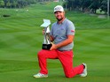 Ryan Moore of USA poses with the CIMB Classic Trophy after he won it in a playoff with Gary Woodland of USA during the playoff during the CIMB Classic at Kuala Lumpur Golf & Country Club on October 28, 2013