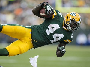James Starks of the Green Bay Packers sails through the air on a tackle by the Washington Redskins at Lambeau Field on September 15, 2013 