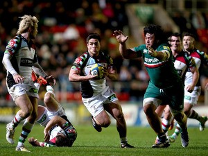 Ben Botica of Harlequins runs under pressure from Logovii Mulipola of Leicester Tigers during the Aviva Premiership match between Leicester Tigers and Harlequins at Welford Road on November 2, 2013