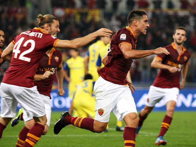 Roma's Marco Borriello celebrates with his teammates after scoring the opening goal during the Serie A match against Chievo Verona on October 31, 2013