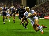 Ryan Hall of England slides over the line to score his second try during the Rugby League World Cup Quarter Final match between England and France at DW Stadium on November 16, 2013