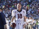 Peyton Manning #18 of the Denver Broncos walks with the football on the sideline during the football game against the San Diego Chargers at Qualcomm Stadium November 10, 2013