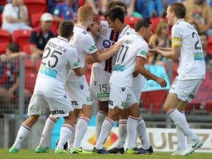 Perth Glory's Chris Harold is congratulated by teammates after scoring the opening goal against Newcastle Jets during their A-League match on January 4, 2013