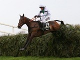 Leighton Aspell riding Pineau De Re jumps the last fence to win the Crabbie's Grand National Chase at Aintree racecourse on April 05, 2014