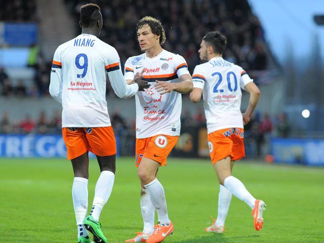 Montpellier's French defender Benjamin Stambouli is congratulated by teammate M'Baye Niang after scoring during the French L1 football match Guingamp against Montpellier on April 5, 2014