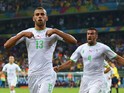 Islam Slimani of Algeria celebrates scoring his team's first goal with Essaid Belkalem during the 2014 FIFA World Cup Brazil Group H match between Algeria and Russia at Arena da Baixada on June 26, 2014