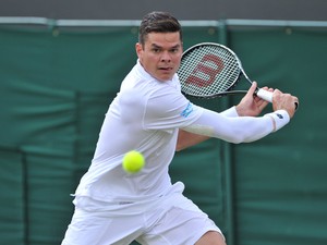 Canada's Milos Raonic returns against Australia's Matthew Ebden during their men's first round match on day two of the 2014 Wimbledon Championships at The All England Tennis Club in Wimbledon, southwest London, on June 24, 2014