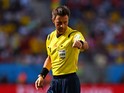 Referee Nicola Rizzoli gestures during the 2014 FIFA World Cup Brazil Quarter Final match between Argentina and Belgium at Estadio Nacional on July 5, 2014