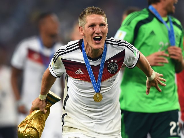 Germany's Bastian Schweinsteiger celebrates with the World Cup trophy on July 13, 2014.