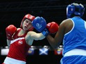 Savannah Marshall of England competes againsts Pearl Moraka of Botswana Women's Middle 69-75kg Division Boxing quarterfinals at Scottish Exhibition And Conference Centre during day seven of the Glasgow 2014 Commonwealth Games on July 30, 2014