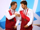England diving duo Nick Robinson-Baker and Freddie Woodward celebrate on the podium after winning Commonwealth Games bronze in the synchronised 3m final on August 1, 2014