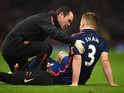 Luke Shaw of Manchester United receives treatment during the Barclays Premier League match between Arsenal and Manchester United at Emirates Stadium on November 22, 2014