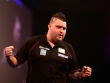 Michael Smith of England celebrates winning his first round match against Mensur Suljovic on December 22, 2014