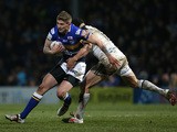 Liam Sutcliffe of Leeds Rhinos is tackled by Hep Cahill of Widnes Vikings during the First Utility Super League match between Leeds Rhinos and Widnes Vikings at Headingley Carnegie Stadium on February 13, 2015