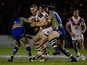 Louie McCarthy-Scarsbrook of St Helens is tackled by Daryl Clark and Chris Hill of Warrington Wolves during the World Club Series match between Warrington Wolves and St George Illawarra Dragons at The Halliwell Jones Stadium on February 20, 2015