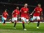 Wayne Rooney of Manchester United celebrates scoring the opening goal with Marcos Rojo and Ashley Young of Manchester United during the Barclays Premier League match between Manchester United and Sunderland at Old Trafford on February 28, 2015