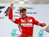 Ferrari's Sebastian Vettel celebrates on the podium after winning the Malaysian Grand Prix on March 29, 2015