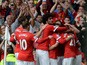 Manchester United players congratulate Manchester United's Spanish midfielder Ander Herrera for scoring the opening goal during the English Premier League football match between Manchester United and Aston Villa at Old Trafford in Manchester, North West E