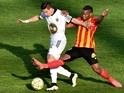 Lorient's French forward Giani Bruno (L) vies with Lens' French midfielder Wylan Cyprien during the French football match between Lens and Lorient on April 12, 2015