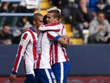 Atletico Madrid's French forward Antoine Griezmann celebrates with his teammates after scoring during the Spanish league football match Malaga CF vs Club Atletico de Madrid at La Rosaleda stadium in Malaga on April 11, 2015