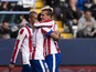 Atletico Madrid's French forward Antoine Griezmann celebrates with his teammates after scoring during the Spanish league football match Malaga CF vs Club Atletico de Madrid at La Rosaleda stadium in Malaga on April 11, 2015