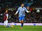 Ron Vlaar of Aston Villa look dejected as Charlie Austin of QPR (9) celebrates as he scores their third goal during the Barclays Premier League match between Aston Villa and Queens Park Rangers at Villa Park on April 7, 2015