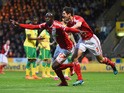 Albert Adomah and George Friend of Middlesbrough celebrate as Alexander Tettey of Norwich City scores their first goal with an own goal during the Sky Bet Championship match between Norwich City and Middlesbrough at Carrow Road on April 17, 2015