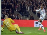Lyon's Cameroonian forward Clinton Njie (R) shoots and scores a goal during the French L1 football match between Lyon and Saint-Etienne on April 19, 2015