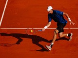 John Isner of USA plays a volley in his match against Steve Johnson of USA during day two of the Monte Carlo Rolex Masters tennis at the Monte-Carlo Sporting Club on April 13, 2015