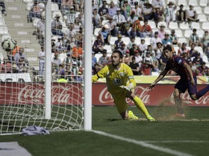 Luis Suarez of FC Barcelona scores their fourth goal past goalkeeper Juan Carlos Martin of Cordoba CF during the La Liga match between Cordoba CF and Barcelona FC at El Arcangel stadium on May 2, 2015