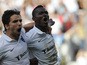 Vitoria SC's Ghanaian midfielder Bernard Mensah celebrates with his teammate forward Tomane after scoring during the Portuguese league football match Vitoria SC vs FC Porto at the Afonso Henriques Stadium in Guimaraes on September 14, 2014