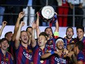 Xavi Hernandez of Barcelona lifts the trophy as he celebrates victory with team mates after the UEFA Champions League Final between Juventus and FC Barcelona at Olympiastadion on June 6, 2015