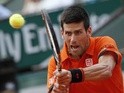 Novak Djokovic plays a backhand stroke during the French Open semi-final against Andy Murray at Roland Garros on June 5, 2015