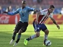 Uruguay's forward Diego Rolan (L) and Paraguay's forward Raul Bobadilla vie for the ball during their 2015 Copa America football championship match, in La Serena, on June 20, 2015