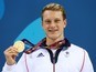 GB swimmer Luke Greenbank poses with his gold medal after winning the men's 100m backstroke at the European Games on June 24, 2015