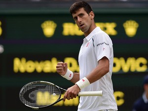 Serbia's Novak Djokovic reacts after breaking the serve of Croatia's Marin Cilic during their men's quarter-final match on day nine of the 2015 Wimbledon Championships at The All England Tennis Club in Wimbledon, southwest London, on July 8, 2015