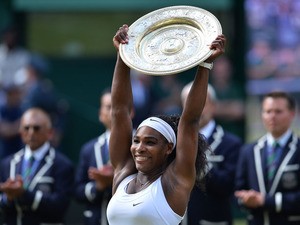 US player Serena Williams celebrates with the winner's trophy, the Venus Rosewater Dish, after her women's singles final victory over Spain's Garbine Muguruza on day twelve of the 2015 Wimbledon Championships at The All England Tennis Club in Wimbledon, s