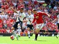 Kyle Walker (L) of Tottenham Hotspur kicks the ball resulting in the own goal during the Barclays Premier League match between Manchester United and Tottenham Hotspur at Old Trafford on August 8, 2015