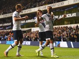 Nacer Chadli of Tottenham Hotspur (R) celebrates with Tommy Carroll (C) and Harry Kane (L) as Calum Chambers of Arsenal scores an own goal foe their first goal during the Capital One Cup third round match between Tottenham Hotspur and Arsenal at White Har