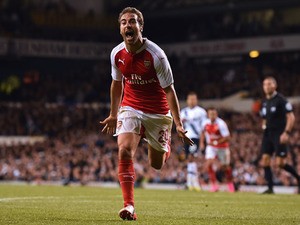 Arsenal's French midfielder Mathieu Flamini celebrates after scoring their seond goal during the English League Cup third round football match between Tottenham Hotspur and Arsenal at White Hart Lane in north London on September 23, 2015