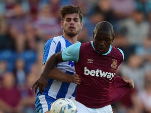 Jordan Brown of West Ham United battles with Joe Edwards of Colchester United during the pre season friendly match between Colchester and West Ham United at Weston Homes Community Stadium on July 21, 2015
