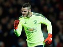 David De Gea of Manchester United celebrates as Juan Mata of Manchester United (not pictured) scores their first and equalising goal from the penalty spot during the UEFA Champions League Group B match between Manchester United FC and VfL Wolfsburg at Old