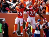 Giovani Bernard #25 of the Cincinnati Bengals is congratulated by Jeremy Hill #32 of the Cincinnati Bengals after scoring a touchdown during the first quarter of the game against the Kansas City Chiefs at Paul Brown Stadium on October 4, 2015